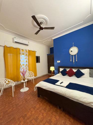 a bedroom with a large bed with a blue wall at The pink house in Jaipur