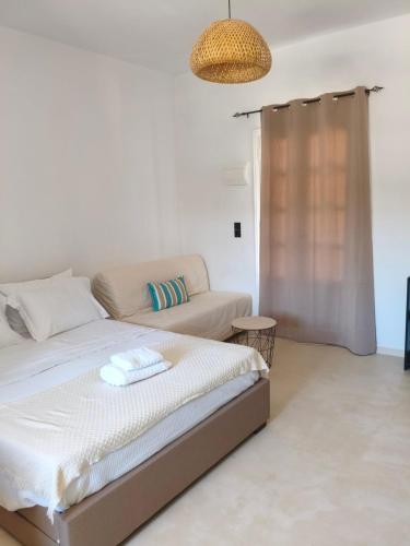 a living room with a bed and a couch at Seaview Apartment in Galissas - Blue Lagoon Complex A9 in Galissas