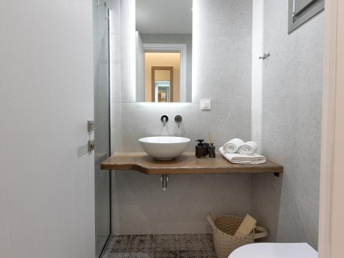 a bathroom with a white sink and a mirror at Pomelo Parga Cozy Studios in Parga