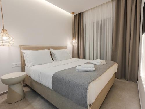 a bedroom with a bed with two towels on it at Pomelo Parga Cozy Studios in Parga