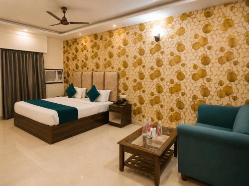 a bedroom with a bed and a couch and a table at Hotel Maurya Heritage In Karol Bagh in New Delhi