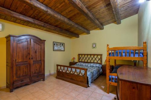a bedroom with two bunk beds and a table at Villa Stefy in Avola