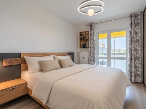 a bedroom with a large bed and a window at Tatra's View Apartment in Poprad