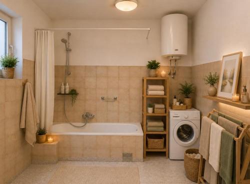 a bathroom with a tub and a washing machine at House by the River in Orja Luka