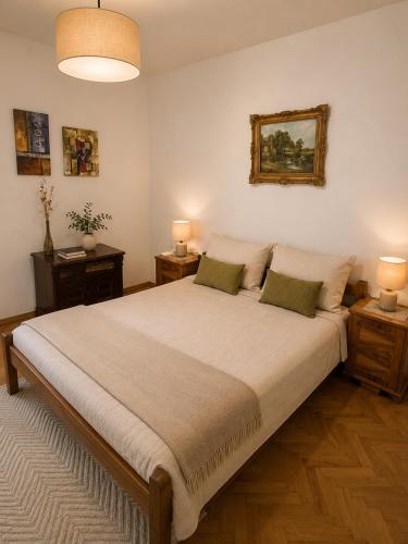 a bedroom with a large bed with two night stands at House by the River in Orja Luka
