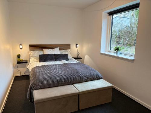 a bedroom with a large bed and a window at Dream house in Glesborg