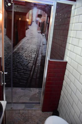 a reflection of a street in a bathroom mirror at RUSTIC MAID´S ROOM in Lövestad