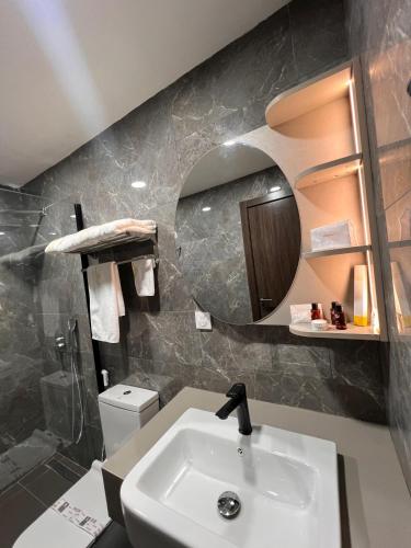 a bathroom with a sink and a mirror at Teral Hotel by Fleur de Lys in Dakar