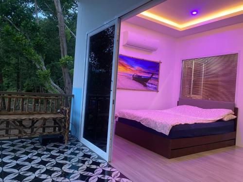 a pink bedroom with a bed and a balcony at Ocean View Tuggi Klong Prao in Klong Prao Beach