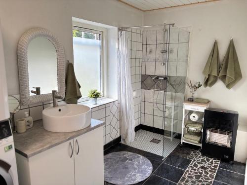 a bathroom with a sink and a shower at Dream house in Glesborg