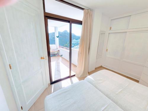 a bedroom with a bed and a large window at Top Flor Ocean View in Playa del Cura