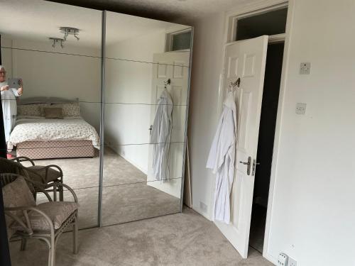 a woman taking a picture of a bedroom with a mirror at Solihull Twin Room Wi-fi, TV in Solihull