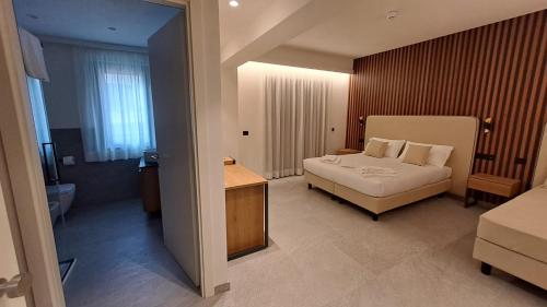 a hotel room with a bed and a bathroom at MOUNTAIN SUITE Hotel Apartment in Tirano