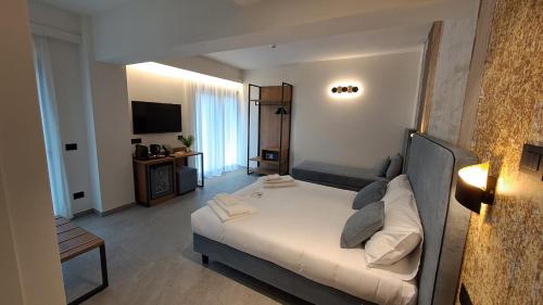 a hotel room with a bed and a television at MOUNTAIN SUITE Hotel Apartment in Tirano