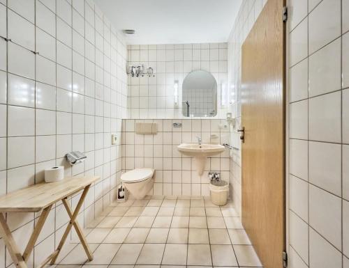 a bathroom with a toilet and a sink and a mirror at Haus Düne, Ferienwohnung 21 in Cuxhaven