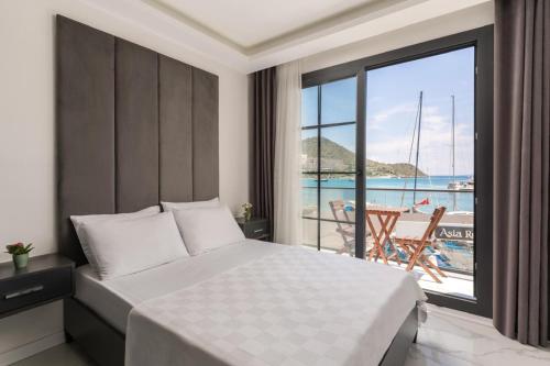 a bedroom with a bed and a view of the ocean at AsiaHOTEL in Bodrum City