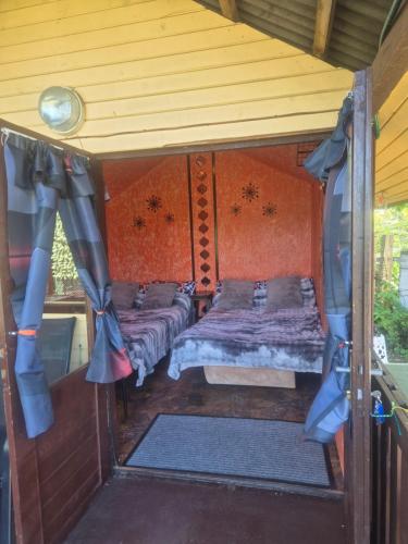 a bedroom with two beds in a house at Pik-Nik Sētiņa in Ventspils