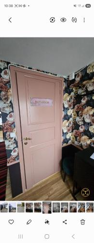 a pink door in a room with a wallpaper at Stiby stugan in Gärsnäs