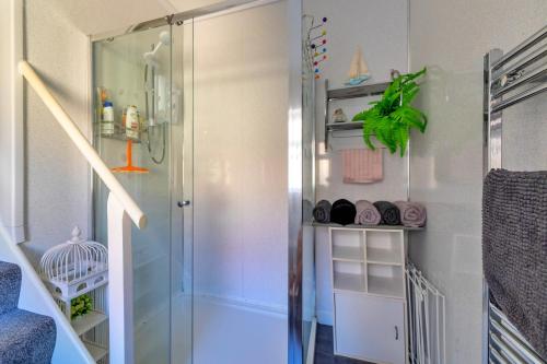 a shower with a glass door in a bathroom at Finest Retreats - Seabreeze, Rhos On Sea in Rhos-on-Sea