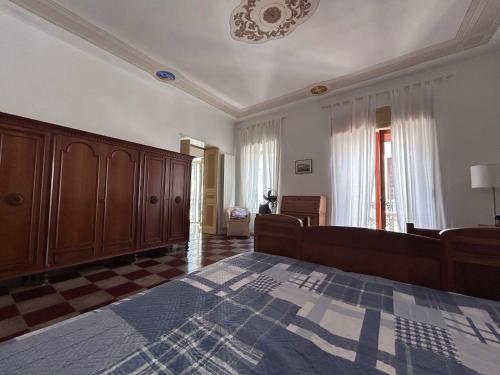 a bedroom with a large bed with a checkered floor at Dimora di Diamante in Diamante