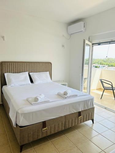 a bedroom with a bed with towels on it at Apartmani ,,Del Mar'' in Ulcinj