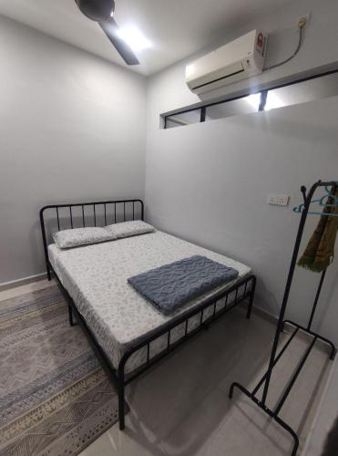 a small bedroom with a bed in a room at Maileyna Homestay 3 in Alor Setar