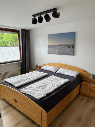 a bedroom with a bed in a room at Birkenweg Ankerplatz II in Carolinensiel