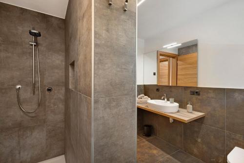 a bathroom with a shower and a sink at Nature House Pflersch in Brennero