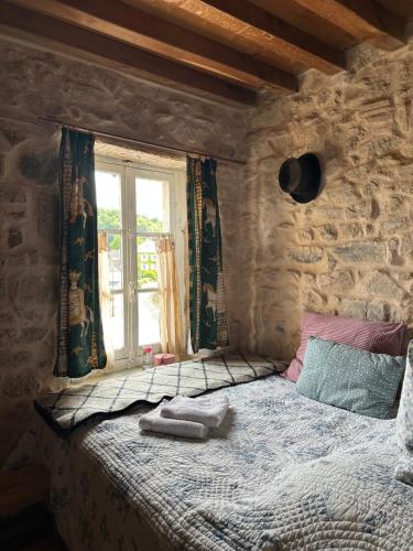 a bedroom with a large bed with a window at MAISON LA TRANQUILITÉ by Frans & Ricardo in Saint-Didier-sur-Arroux