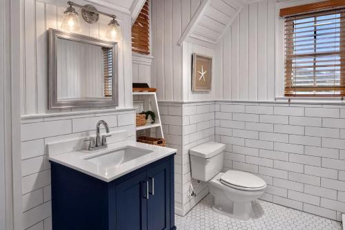a bathroom with a sink and a toilet at 07-Founders Suite at The Castle Inn in Ocracoke