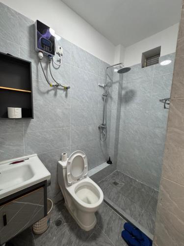 a bathroom with a shower and a toilet and a sink at Jambo luxury living in Marimbeti