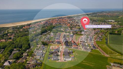 an aerial view of a city with the ocean at Welcome in - Appartement met zonnig terras, nabij centrum Zoutelande I Borne 56a in Zoutelande