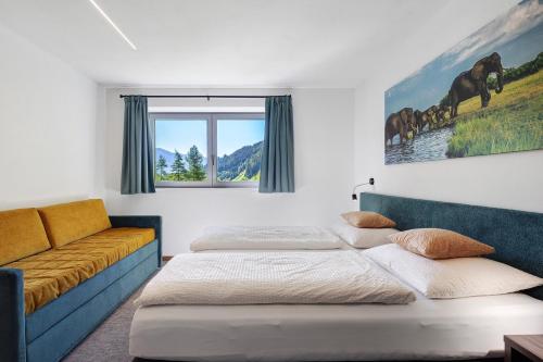 a bedroom with two beds and a couch at Nature House Pflersch in Brennero