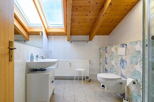 a bathroom with a toilet and a sink at Haus Seewind Warnemünde in Rostock