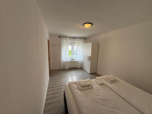 a bedroom with a bed with two towels on it at Ferienwohnung Soltau in Soltau