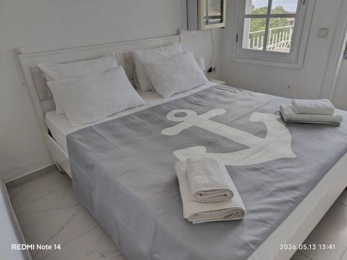a white bed with towels and towels on it at Club Çapa Hotel in Kaş