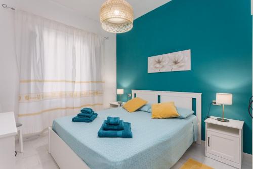 a bedroom with blue walls and a bed with blue sheets at Villa Damiano in Tertenìa