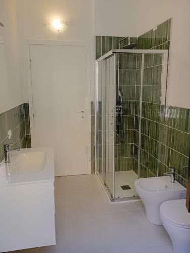 a bathroom with a shower and a toilet and a sink at La finestra sulla campana in Brescello
