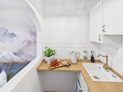 a kitchen with a sink and a counter with fruit on it at Alpenblick 5 - Chiemgau Karte in Inzell