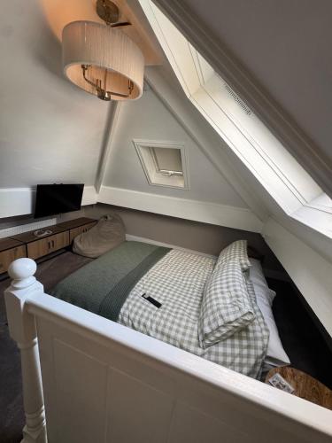 a room with a bed under the stairs at Harehills House in Killingbeck