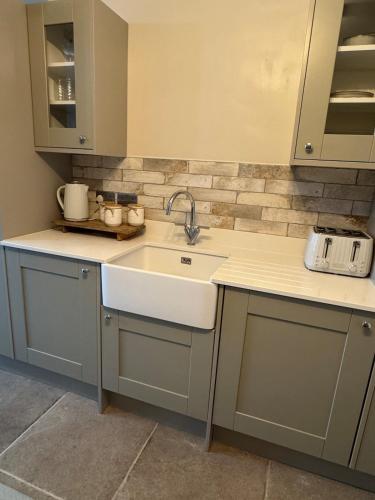a kitchen with a sink and a counter top at Harehills House in Killingbeck