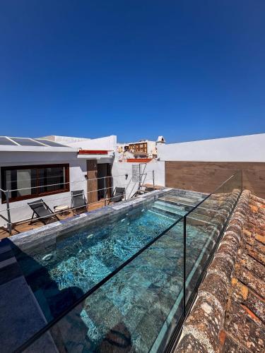 a swimming pool on the roof of a building at Amaranta Hotel Boutique in Ronda