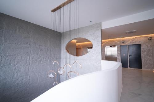 a bathroom with a white counter and a mirror at Waves Hotel NEW IN 2026 in Sarajevo