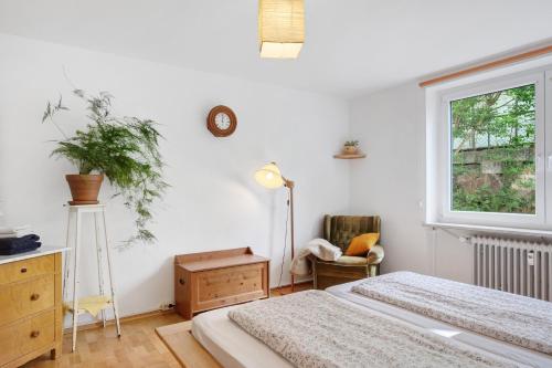 a bedroom with two beds and a window and a chair at Ferienwohnung Am Seebach, 80 Qm in Titisee-Neustadt