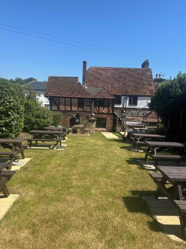 a row of picnic tables in front of a building at The Village House in Findon