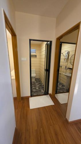 a room with a bathroom with a toilet and two mirrors at Dumba Bay Tioman in Tioman Island