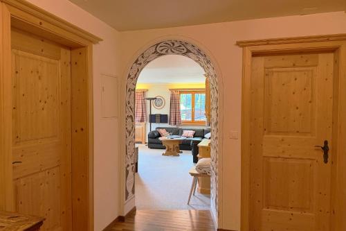 an archway in a room with a living room at Panorama Apartment Gotschnablick 1-6 Pers in Klosters