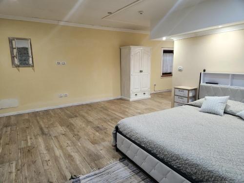 a bedroom with a bed and a wooden floor at Il Pozzo dei Desideri Vintage in Spilimbergo