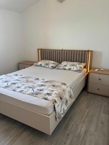 a bed in a bedroom with two pillows on it at Lana&Ema in Kali