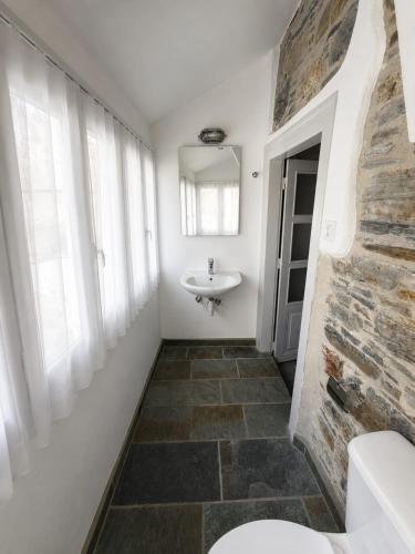 a bathroom with a sink and a mirror and a toilet at Samos Vista Azzurra 2 in Samos